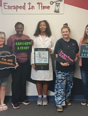 a group of people playing the birds aren't real escape room at Escaped In Time